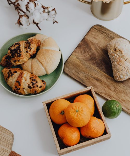 kaboompics_orange-croissant-cutting-board-ona-table-15836